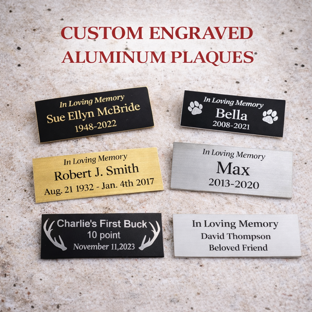 Collection of custom engraved aluminum plaques on a textured surface
