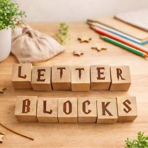 Natural wooden letter blocks spelling “LETTER BLOCKS” on a light wood table with educational decor