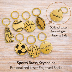 Collection of sports-themed brass keychains on a wooden surface with text about engraving options.