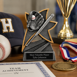 Personalized baseball trophy with engraved name plate displayed on a wooden table alongside a baseball medal, championship trophy, baseball cap, and team achievement certificate.
