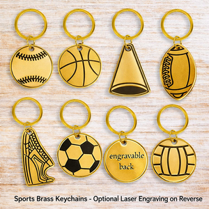 Set of sports-themed brass keychains on a wooden surface