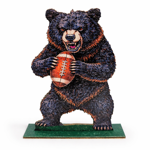 Bear figurine holding a football on a white background